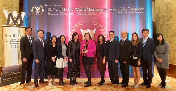 Hazel Etherington (centre), COO of Transamerica Life Bermuda, celebrates Outstanding Achiever award with her team at the 10th Benchmark Wealth Management Awards.