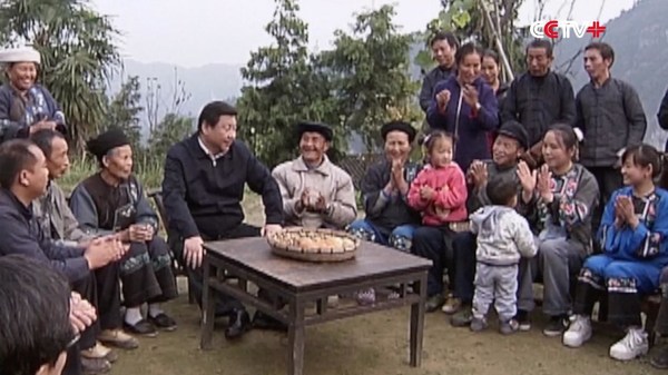 photo of President Xi Jinping with people in poor region