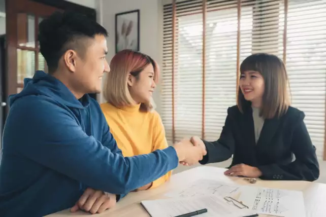 A female real estate negotiator (REN) closing the deal with clients common in the real estate industry