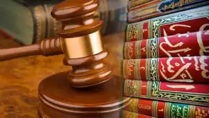 A gavel being hit on a circular wooden block in a court of law and an image of a stack of Al-Quran or Islamic books is superimposed next to it.